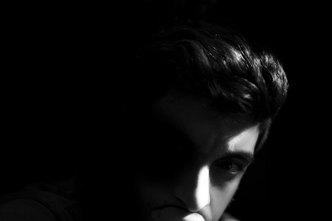 Studio portrait of a man with short dark hair