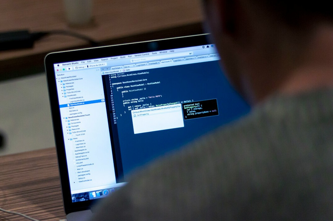 person debugging code on screen
