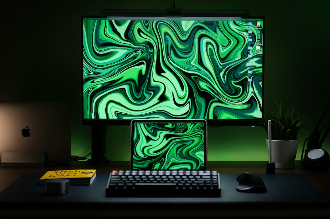 Dual monitor setup displaying programming code